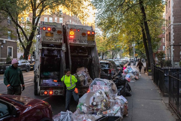 Sanitation workers collect trash on Nov. 16, 2024, in the Brooklyn borough of New York. (Yuki Iwamura/AP)