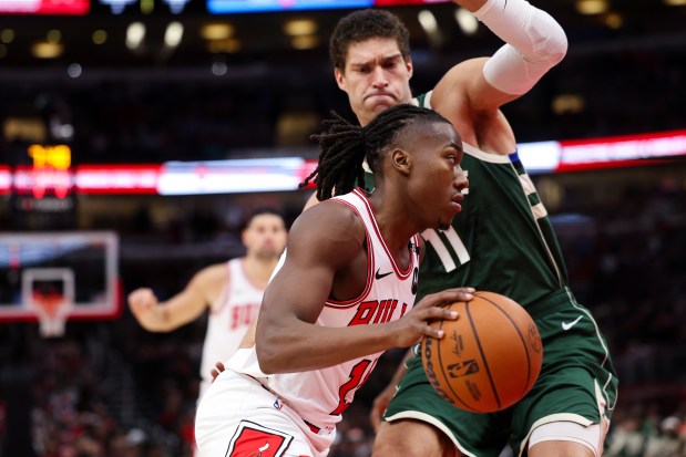 Chicago Bulls guard Ayo Dosunmu (11) drives against Milwaukee Bucks center Brook Lopez (11) during the first period at the United Center Monday Dec. 23, 2024, in Chicago. (Armando L. Sanchez/Chicago Tribune)