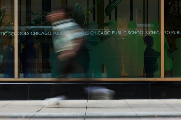 A student runs past the Chicago Public Schools central office at 42 W. Madison St. on Oct. 31, 2024. (John J. Kim/Chicago Tribune)