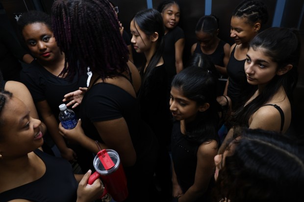 Dance students take an elevator to their rehearsal room before performing in the 61st annual Winter Arts Showcase, a production by the Chicago Public Schools All-City Performing Arts (ACPA) program, at Jones College Prep on Dec. 14, 2024. (John J. Kim/Chicago Tribune)