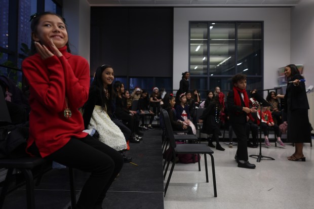 Choir students in grades 3-5 get a pep talk before performing in the 61st annual Winter Arts Showcase at Jones College Prep. (John J. Kim/Chicago Tribune)