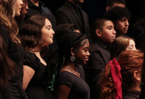 Choir student Lyla Campbell, 13, center, pauses to smile while singing with fellow students in grades 6-12 in the 61st annual Winter Arts Showcase at Jones College Prep on Dec. 14, 2024. (John J. Kim/Chicago Tribune)