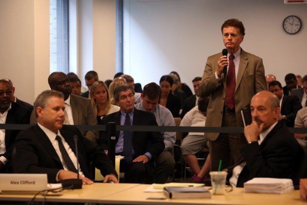 Thomas Homer, then-legislative inspector general, stands before the Regional Transportation Authority board on July 17, 2013, in Chicago. Former Metra CEO Alex Clifford, left, triggered an investigation by alleging that Michael Madigan was making personnel requests. Homer conducted the inquiry. (Nancy Stone/Chicago Tribune)