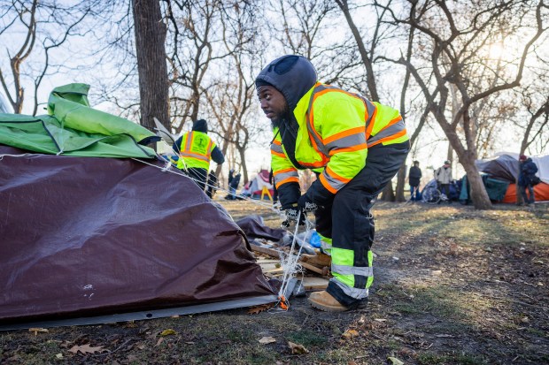 City workers clear the Humboldt Park homeless encampment in Chicago on Dec. 6, 2024. (Tess Crowley/Chicago Tribune)