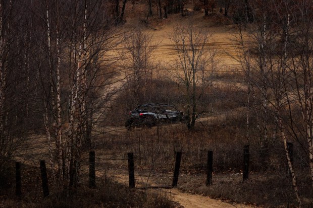 An ATV drives through a sand dune on private property on Dec. 15, 2024, in Hopkins Park. (Armando L. Sanchez/Chicago Tribune)