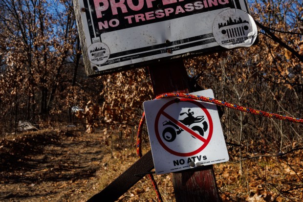 A fence and trespassing signs block a path to a sand dune located on private property behind homes and used frequently by ATV's on Dec. 1, 2024, in Hopkins Park. (Armando L. Sanchez/Chicago Tribune)