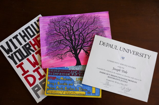 Artwork and the diploma of Joe Dole lies on a table at the home of his friend, Shari Stone-Mediatore, on Nov. 26, 2024. (Eileen T. Meslar/Chicago Tribune)