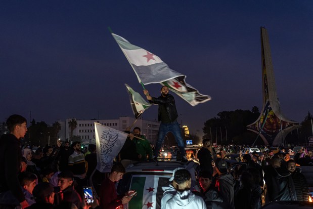 People gather in Umayyad Square in Damascus, Syria's capital, to celebrate the ouster of President Bashar Assad on Monday, Dec. 9, 2024. The Biden administration is scrambling to find ways to engage with groups in Syria and around the Middle East as victorious militias begin shaping the nation's future after the toppling of President Bashar al-Assad, the longtime autocrat. (Daniel Berehulak /The New York Times)