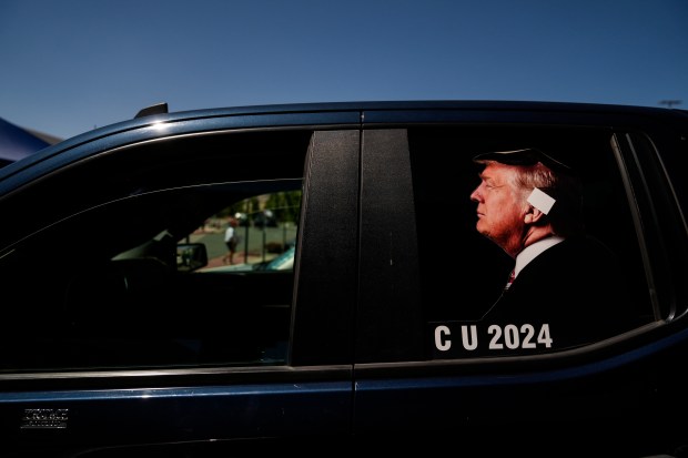 A photo of Republican presidential candidate Donald Trump with an ear bandage is posted on a pickup truck before a campaign event with Republican vice presidential candidate Sen. JD Vance in Reno, Nevada, on July 30, 2024. (Jae C. Hong/AP)