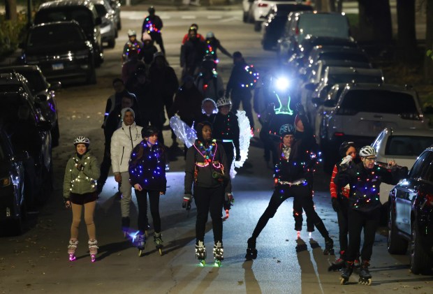 Windy City Skaters roll south on North Marshfield Avenue during their Holiday Lights Road Rave through city neighborhoods on Nov. 22, 2024. (John J. Kim/Chicago Tribune)