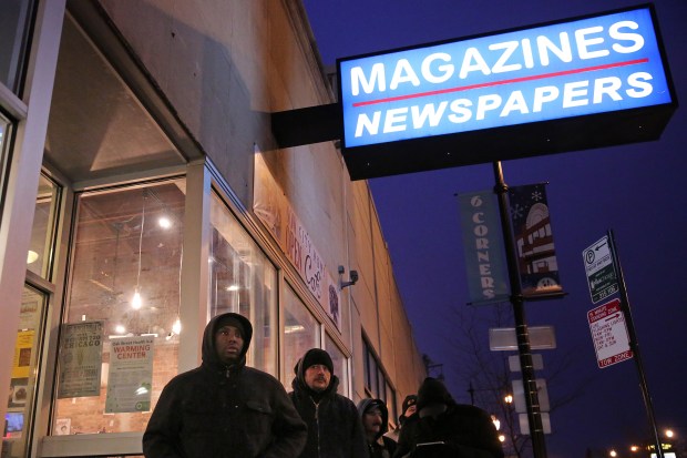 People wait in line to purchase Charlie Hebdo, a French satirical weekly magazine, on Jan. 23, 2015, at City Newsstand (now City News Cafe) in Chicago. (Anthony Souffle/Chicago Tribune)