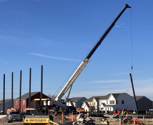 As dignitaries signed a ceremonial beam at Forrestal Elementary School in North Chicago, a construction crew placed real ones. (Steve Sadin/For the Lake County News-Sun)