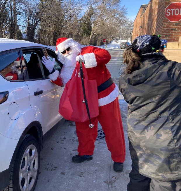 Santa Claus helped with a food distribution for Waukegan schoolchildren. (Steve Sadin/For the Lake County News-Sun)