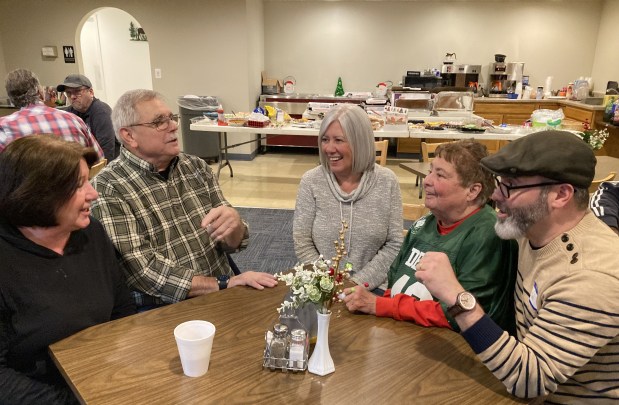 Talking at the anniversary party are, from left, Sallie Koss, Ken Koss, Jane Lambiris, Debby Ramsey and Kevin Ramey. (Steve Sadin/For the Lake County News-Sun)