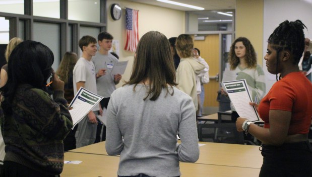 Students in joint class from Waukegan and New Trier high schools look at their assignment. (Courtesy of Waukegan Community Unit School District 60)