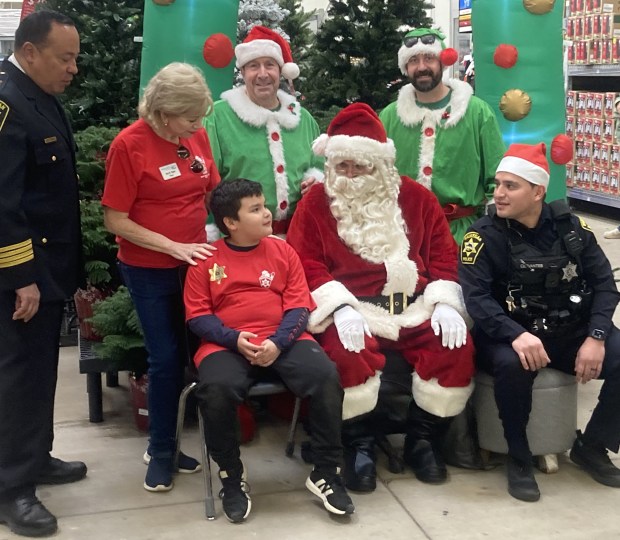 Before shopping with a Waukegan police officer, youngsters got a chance to talk to Santa Claus. (Steve Sadin/For the Lake County News-Sun)