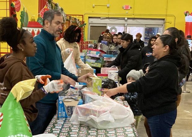 Shoppers check out with their holiday gifts. (Steve Sadin/For the Lake County News-Sun)