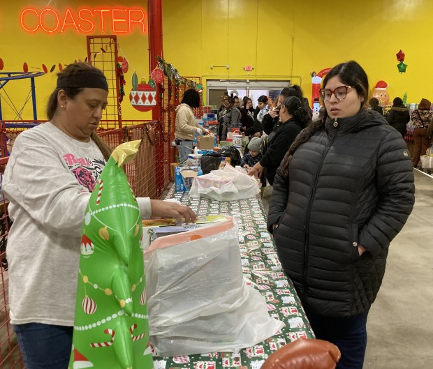 Volunteers at the Toys for Tots effort in Waukegan talk about a display. (Steve Sadin/For the Lake County News-Sun)