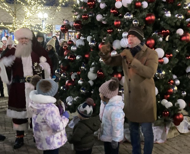 A family and Santa Claus gather before the Waukegan tree lighting ceremony. (Steve Sadin/For the Lake County News-Sun)