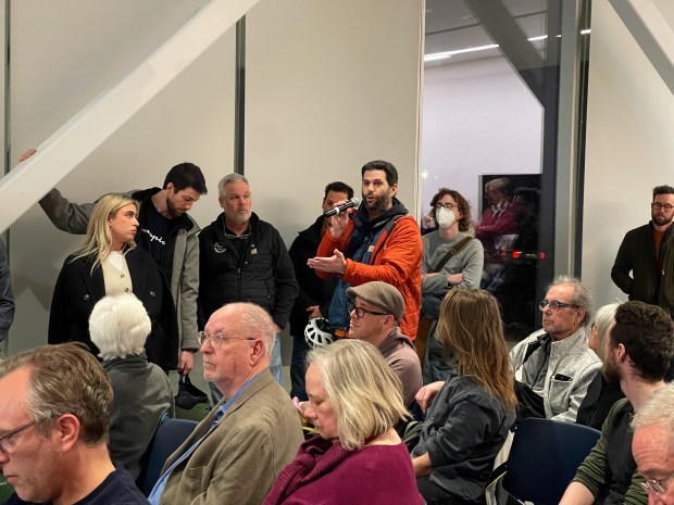 Gabe Weiss, an Evanston cyclist, speaking in favor of a proposed Chicago Avenue bike lane from Davis Street to Howard at a community event on Dec. 10, 2024. (Richard Requena/Pioneer Press)