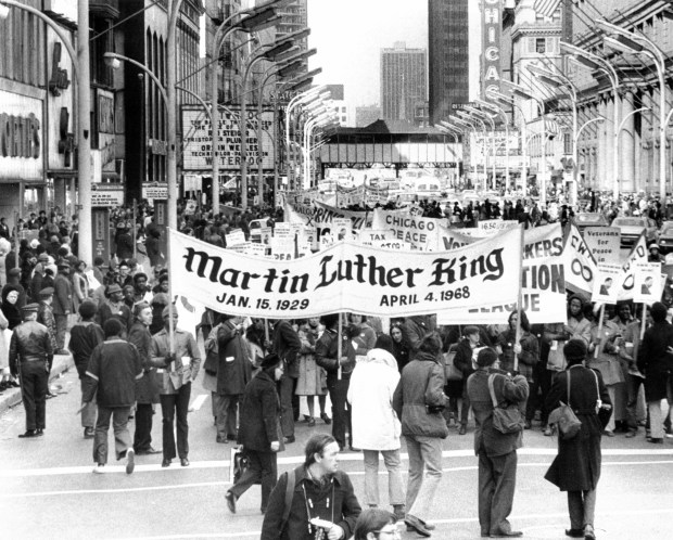 A crowd parades down State Street to the Coliseum on April 3, 1971, in Chicago in memory of slain civil rights leader Rev. Martin Luther King Jr. In the years after King's death, memorial events occurred in April and January to honor him. In 1973, Illinois was the first state to make MLK Day a legal holiday.