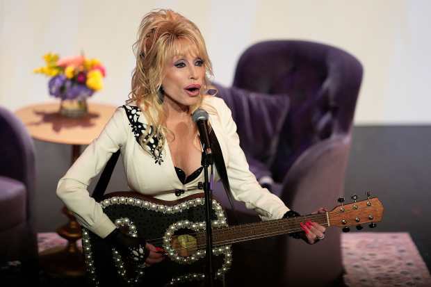 Dolly Parton performs during an event in Kansas City, Missouri, celebrating the expansion of her Imagination Library on Aug. 27, 2024. On Friday, the Fox Valley United Way opened sign-ups for Dolly Parton's Imagination Library for residents in Kane and Kendall counties. (Charlie Riedel/Associated Press)