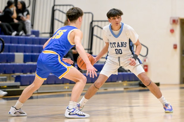 IMSA's Neil Sitapara (00) looks to move past Aurora Central Catholic's Ben Bohr (15) during a game at home in Aurora on Thursday, Jan. 23, 2025. (Mark Black / for the Beacon-News)