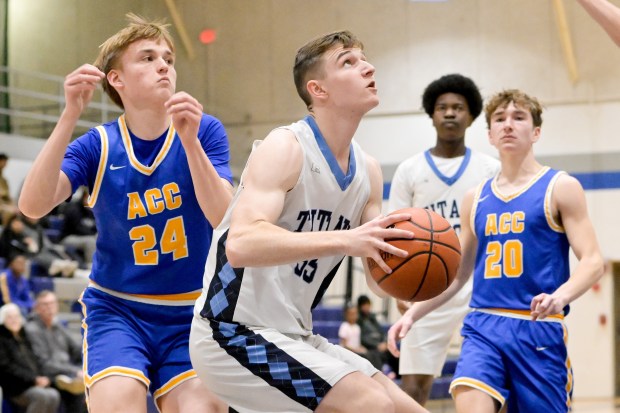 IMSA's Xander Albertson (35) works for a shot against Aurora Central Catholic during a game in Aurora on Thursday, Jan. 23, 2025. (Mark Black / for the Beacon-News)