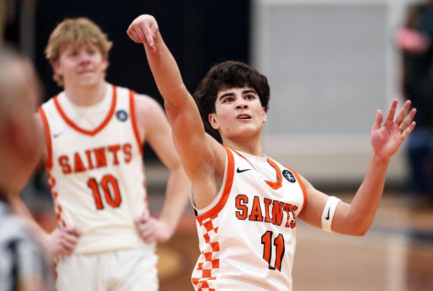 St. Charles East's Gavin Szerlong (10) and Reese Dumpit (11) use a little body english so a free throw will drop in the fourth quarter against Batavia during a DuKane Conference game in St. Charles on Friday, Jan. 10, 2025.H. Rick Bamman / For the Beacon News