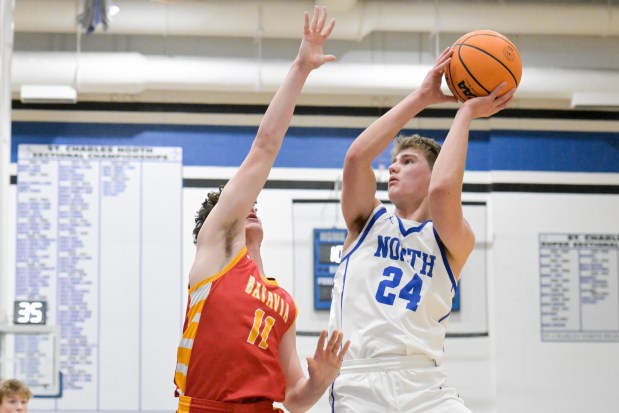 St. Charles North's Colin Hopp (24) takes a shot over Batavia's Josh Kahley (11) during a game at home on Thursday, Jan. 30, 2025. (Mark Black / for the Beacon-News)