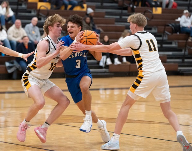 Burlington Central's Lucas Kerr pushes through the defense of Jacobs' Connor Goehring, left, and Carson Goehring during their game at Jacobs High School in Algonquin on Wednesday, Jan. 22, 2025. (Ryan Rayburn/for the Aurora Beacon News)