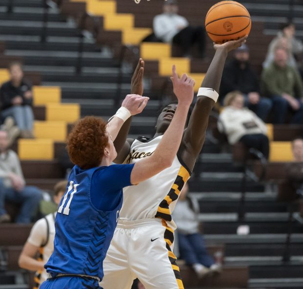 Jacobs' Samson Averehi shoots over Burlington Central's Patrick Shell during their game at Jacobs High School in Algonquin on Wednesday, Jan. 22, 2025. (Ryan Rayburn/for the Aurora Beacon News)