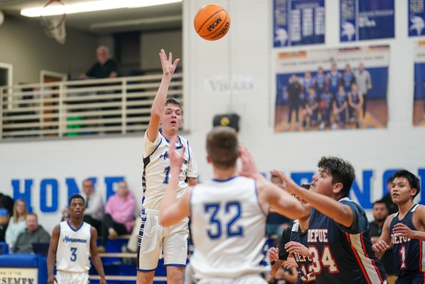 Newark's Dylan Long (13) passes the ball into the post to Cody Kulbartz (32) during a basketball game against DePue at Newark High School on Tuesday, Jan. 14, 2025. (Sean King / for The Beacon-News)