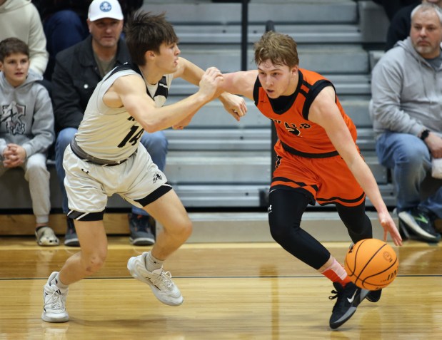 DeKalb's Sean Reynolds (2) drives against Kaneland's Preston Popovich (14) in the first quarter during a non-conference game in Maple Park on Tuesday, Jan. 28, 2025.H. Rick Bamman / For the Beacon News