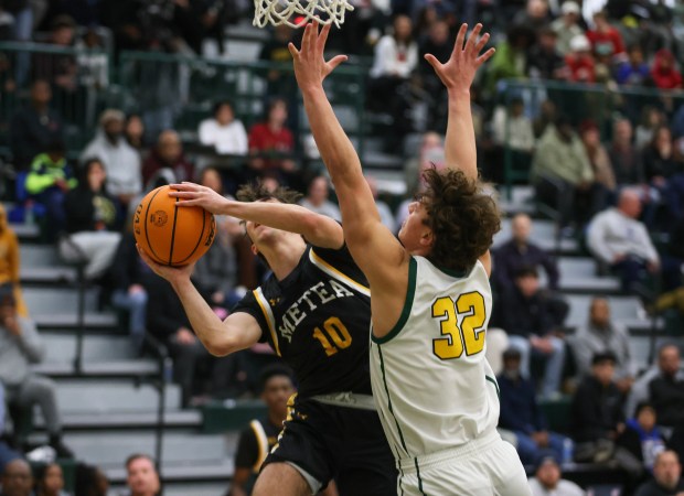 Waubonsie's Tyus Payne (32) defends against Metea's Tyler Miller (10) during a basketball game in Aurora, Ill. on Friday, Jan. 24, 2025.(Mike Mantucca-For The Beacon-News)