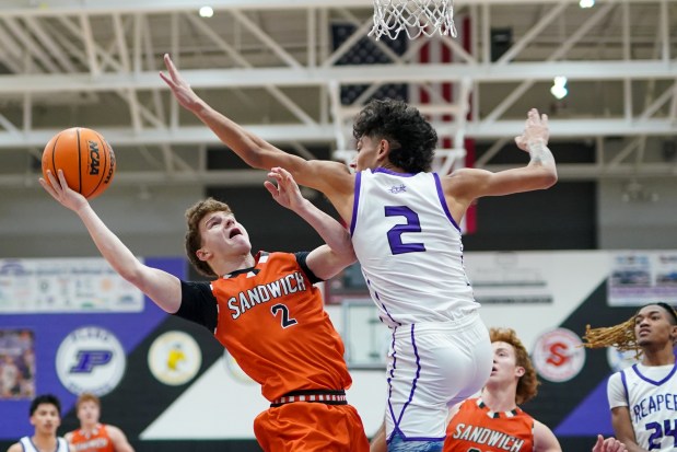 Sandwich's Griffin Somlock (left), shoots the ball in the post against Plano's Gabe Steele during a Kishwaukee River Conference basketball game at Plano High School on Monday, Jan. 27, 2025. (Sean King / for The Beacon-News)