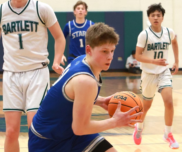 St. Charles North's Cooper Mellican charges the basket during the basketball game against Bartlett in Bartlett on Tuesday, Jan. 28, 2025. (James C. Svehla / for the Beacon-News)