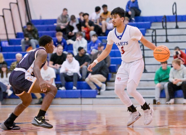 Marmion's Ali Tharwani (5) looks for an opening against St. Francis de Sales during a game at home in Aurora on Friday, Jan. 17, 2025. (Mark Black / for the Beacon-News)