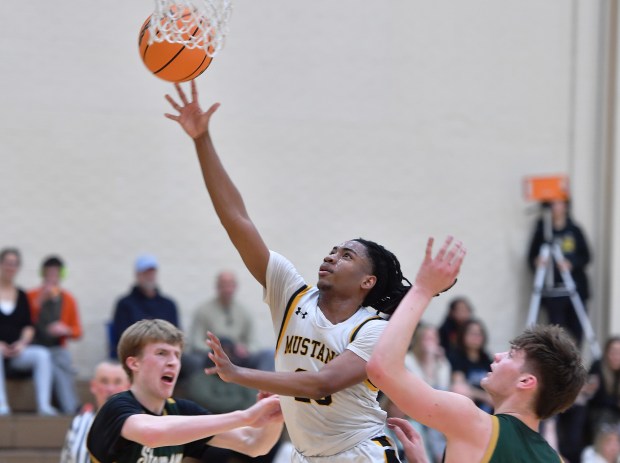 Metea Valley's Koi Young shoots over two Stevenson defenders during a MLK Tournament game on Saturday, Jan. 18, 2025 in Wheaton...(Jon Cunningham/for The Beacon-News)