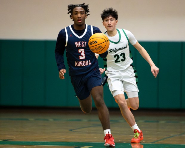 West Aurora's Jaden Edwards (3) dribbles down the court during a game against Ridgewood in Norridge on Thursday, Jan. 23, 2025. (Nate Swanson / for the Beacon-News)