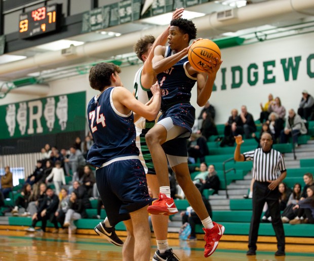 West Aurora's Travis Brown (1) passes the ball during a game against Ridgewood in Norridge on Thursday, Jan. 23, 2025. (Nate Swanson / for the Beacon-News)