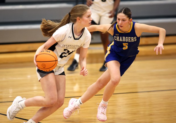 Aurora Central Catholic's Grace Grunloh (5) defends Kaneland's Samantha Kerry (20) in the first quarter during a non-conference game in Maple Park on Tuesday, Jan. 7, 2025.H. Rick Bamman / For the Beacon News