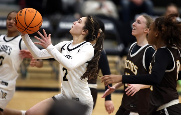 Streamwood's Ayumi Ishikawa (2) out runs Jacobs' defenders Mallory Fessler (11) and Zara Lewis (10) to score in the third quarter during a non conference game in Streamwood on Monday, Jan. 27, 2025.(H. Rick Bamman/for the Beacon-News)