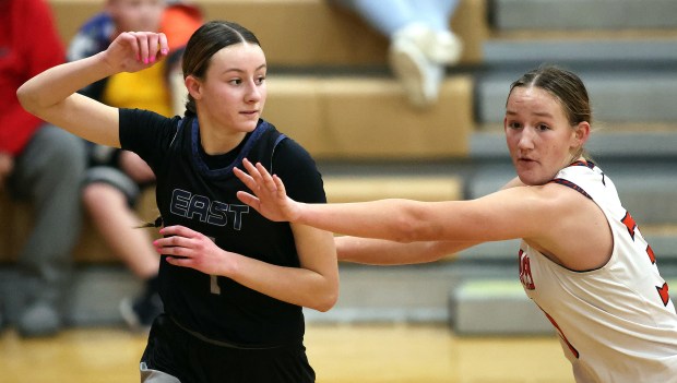 Oswego East's Aubrey Lamberti (1)looks for a pass against Oswego's Peyton Johnson (30) in the fourth quarter during a Southwest Prairie conference game in Oswego on Wednesday, Jan. 22, 2025.H. Rick Bamman / For the Beacon News