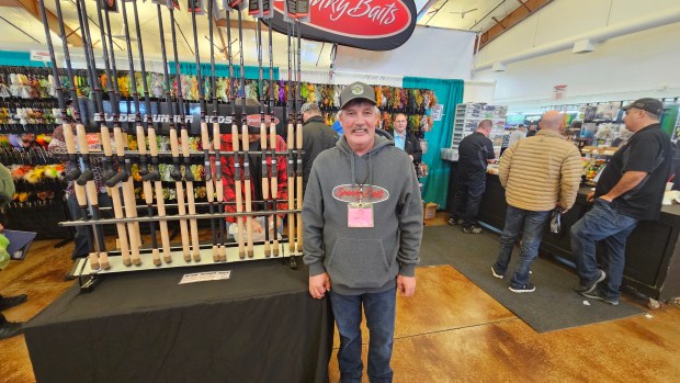 Cal Ritchie from Ontario, Canada, was helping visitors buy lures last weekend at the annual Muskie Expo Chicago event at the Kane County Fairgrounds in St. Charles. (David Sharos / For The Beacon-News)