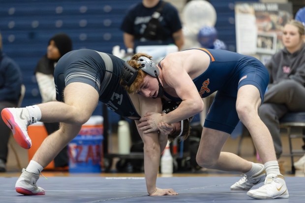 Oswego's Dillon Griffin wrestles Oswego East's Brayden Felice during a wrestling match in Oswego on Tuesday, Jan. 16, 2025. (Troy Stolt / for the Daily Southtown)