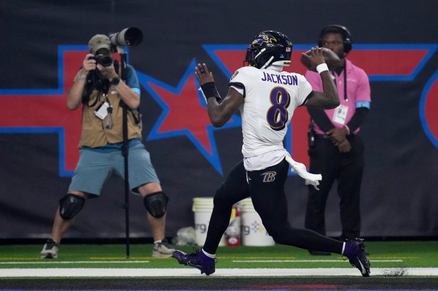 Ravens quarterback Lamar Jackson celebrates after a 48-yard touchdown run against the Texans, on Dec. 25, 2024, in Houston. (David J. Phillip/AP)