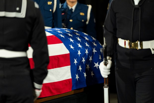 Mourners view the changing of guard of the joint services military honor guard as the casket of former President Jimmy Carter as he lies in repose at the Jimmy Carter Presidential Library and Museum in Atlanta, Tuesday, Jan. 7, 2025. Carter died Dec. 29 at the age of 100. (AP Photo/Alex Brandon, Pool)