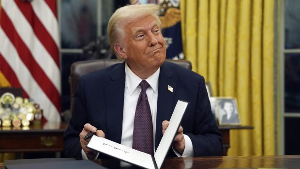 President Donald Trump signs executive orders in the Oval Office of the White House, Monday, Jan. 20, 2025, in Washington. (AP Photo/Evan Vucci)