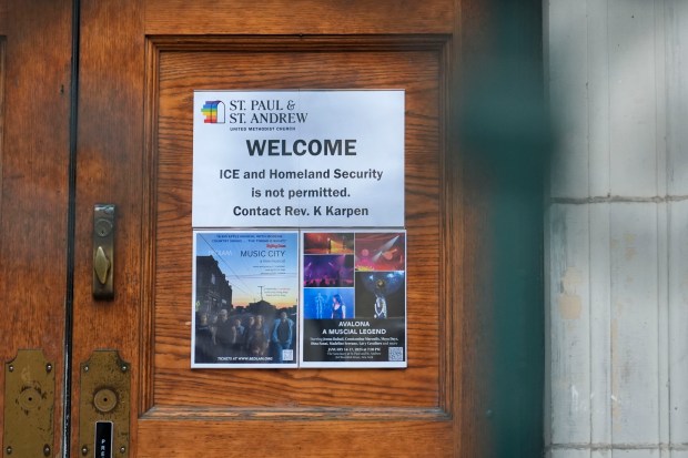 A sign that prohibits the entrance of ICE or Homeland Security is posted on a door at St. Paul and St. Andrew United Methodist Church in New York, Tuesday, Jan. 21, 2025. (AP Photo/Seth Wenig)